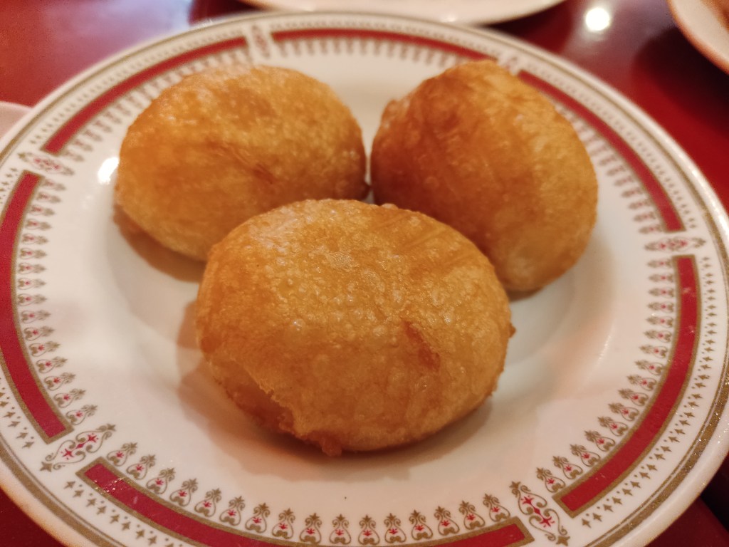 Three deep fried rice dumplings on a plate