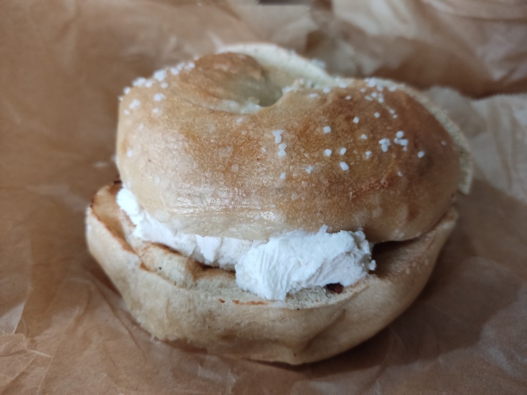 A salt bagel with a cream cheese filling