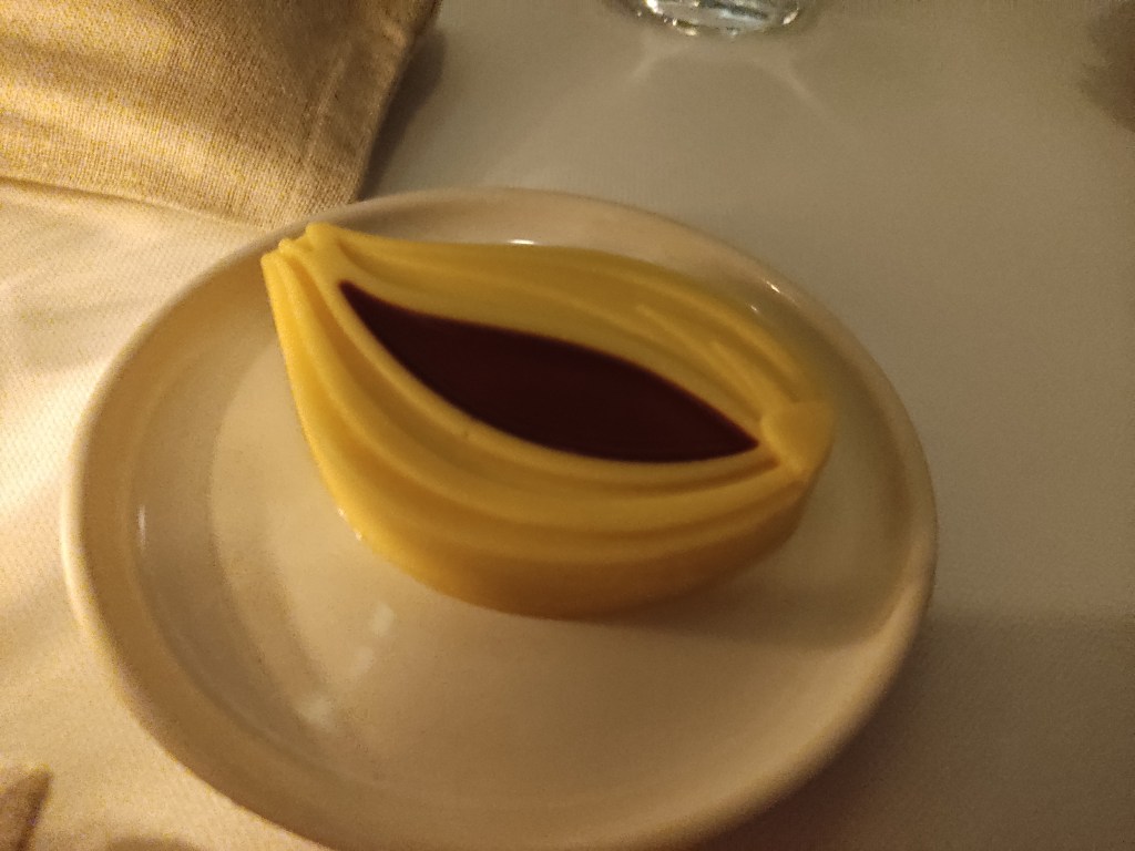 A portion of butter shaped like a bulb or clove, with a darker, garlic flavoured centre