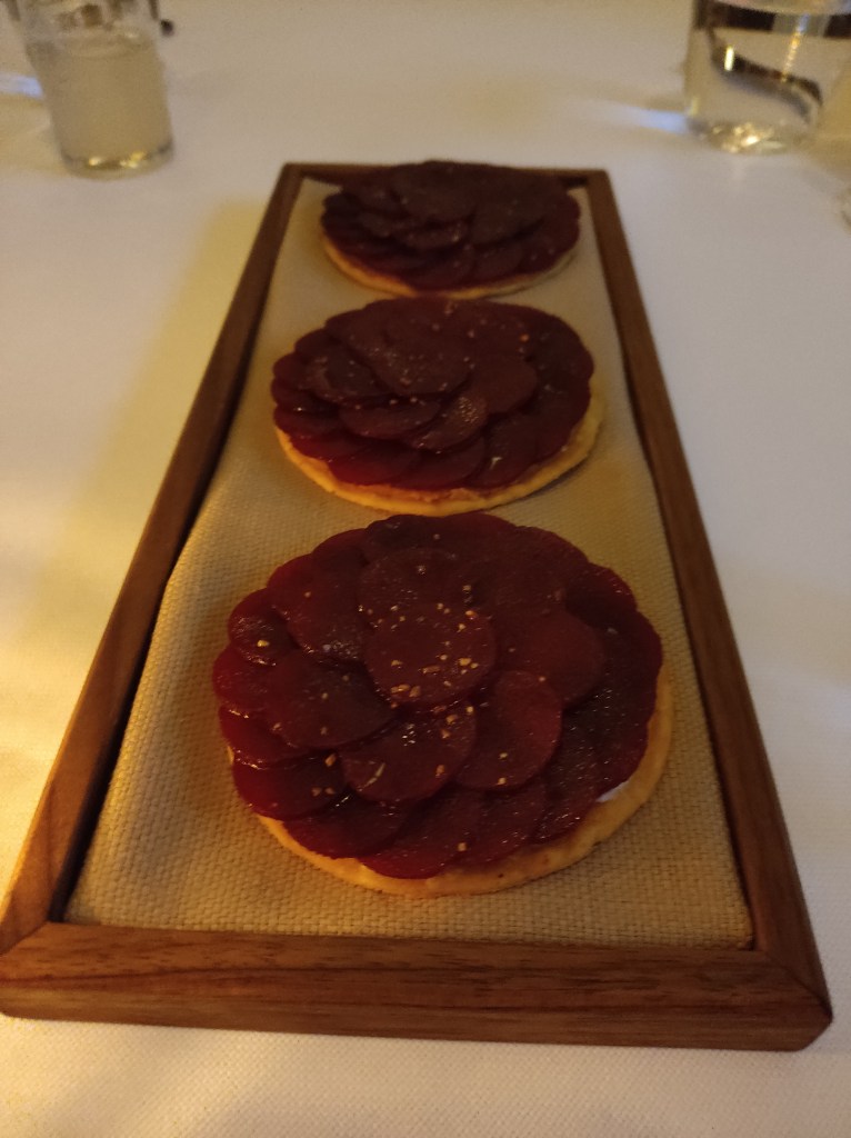 Three crispy tostadas topped with artfully arranged beettoor slices