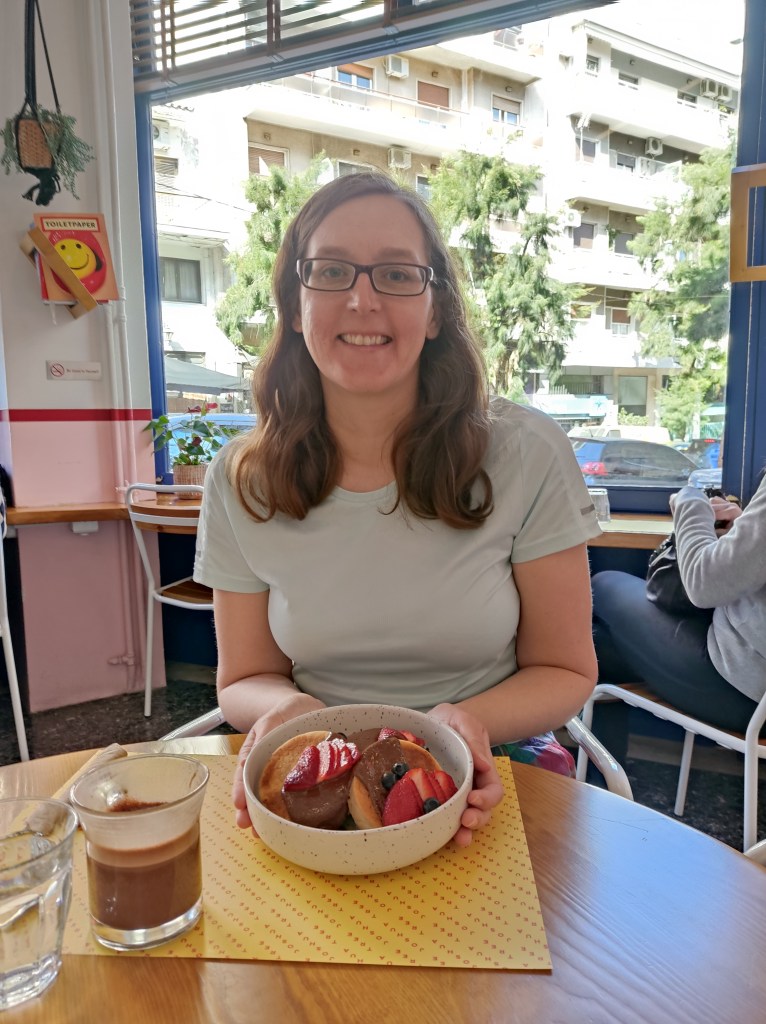 Jenny is smiling with a bowl of hot cakes