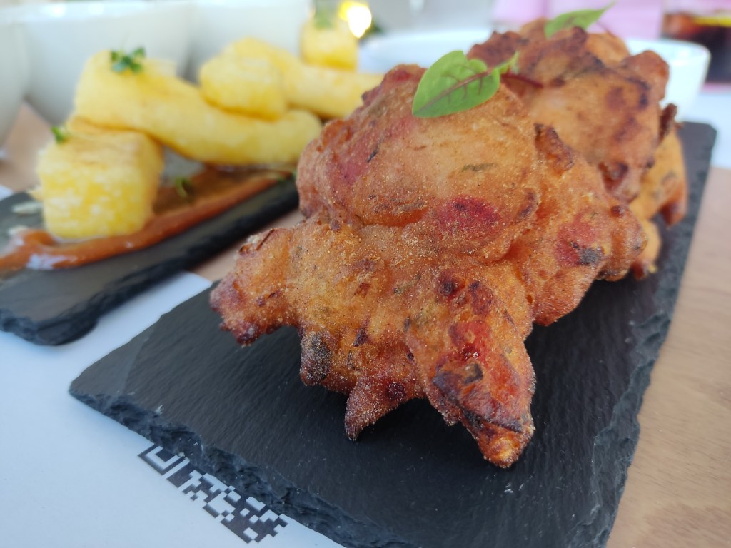 Deep fried tomato fritters, with the fried cheese in the background