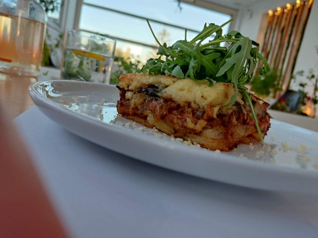 Moussaka topped with rocket