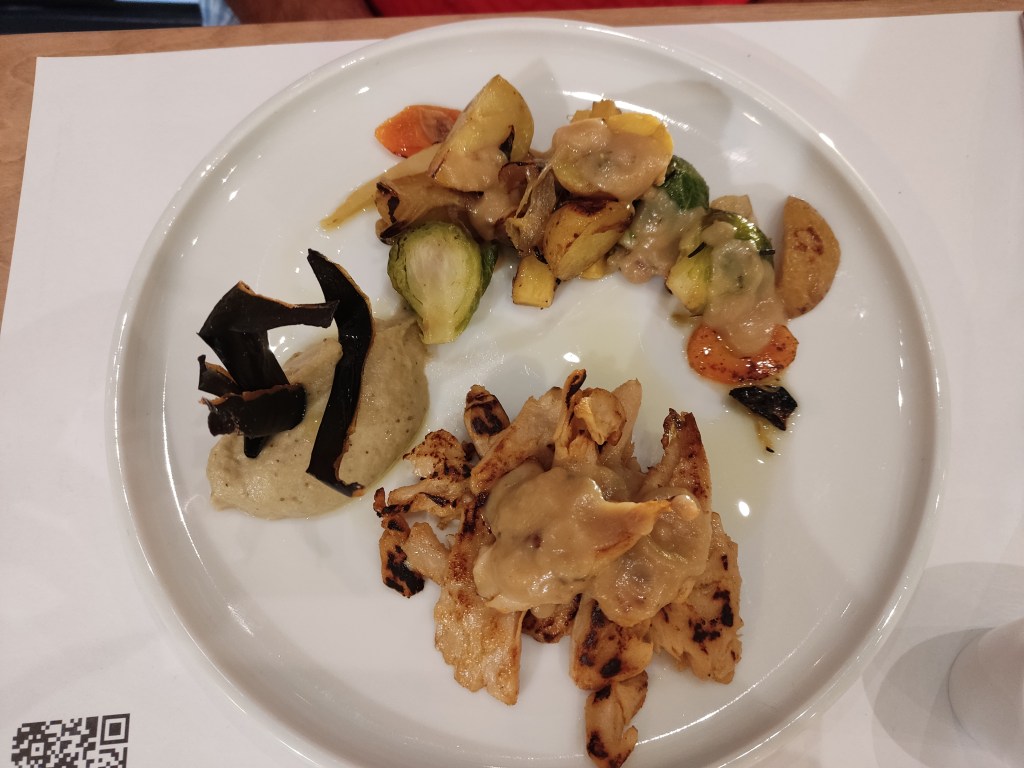 Chicken strips in a thick white wine sauce with a quenelle of aubergine puree and some roasted vegetables