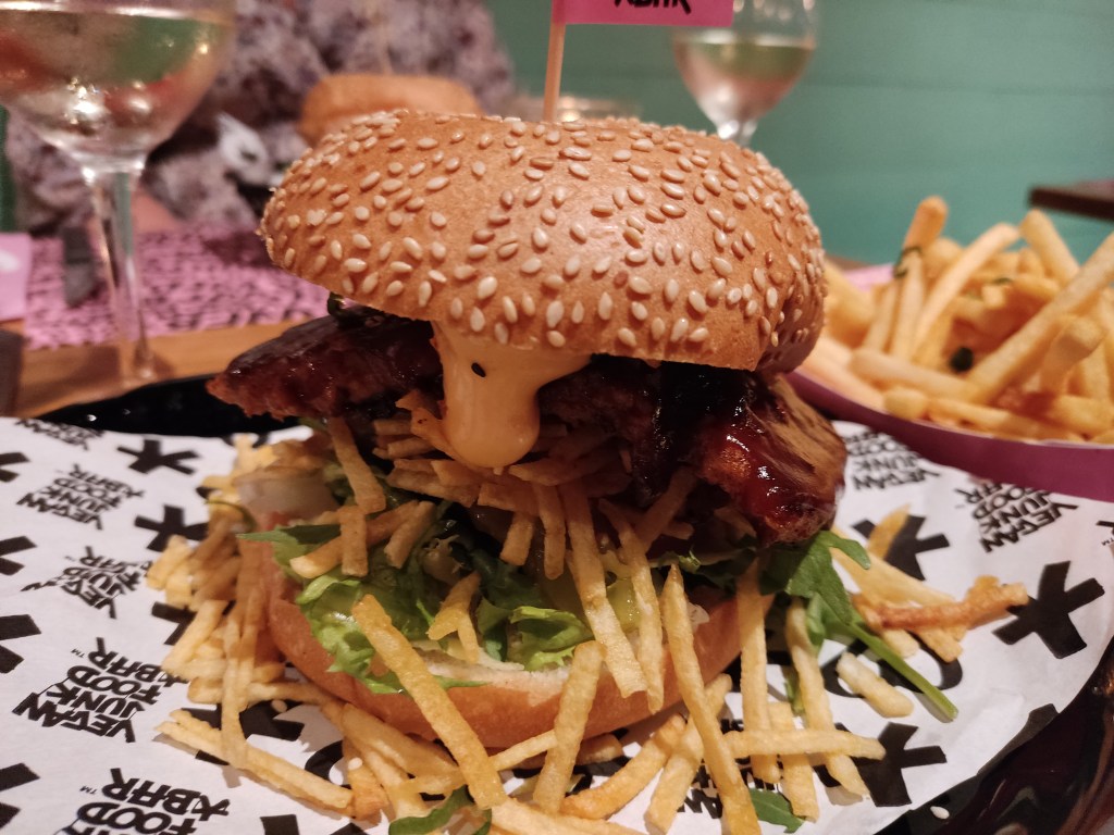 A big burger with a massive sticky slab of ribs in it