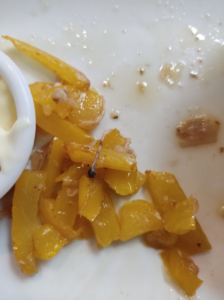 A pile of oily yellow pepper chunks picked out of the "fish"