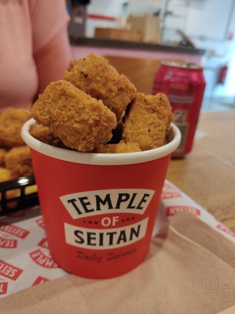 A pot piled high with uniform chunks of battered popcorn chicken