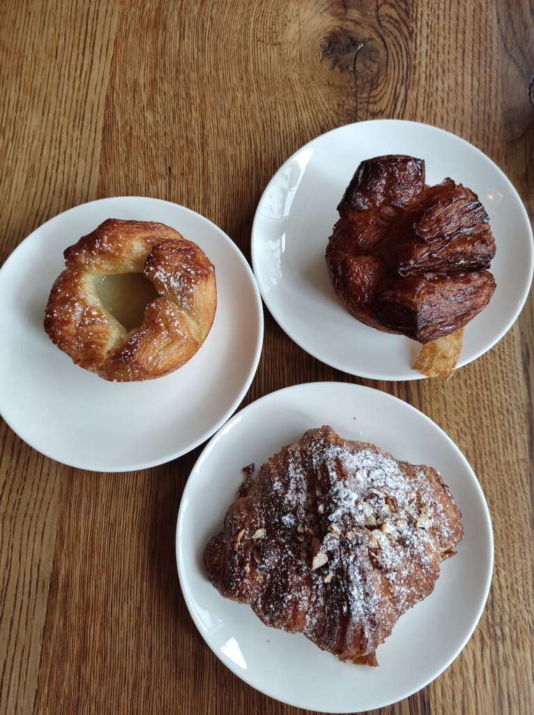 Three vegan pastries - a cardamom croissant, gigantic chocolate croissant, and spandauer