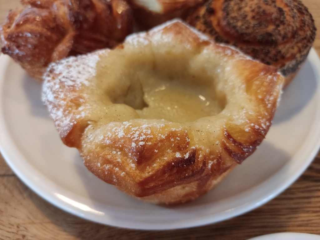 A pastry cup with nice laminated edges, filled with creamy custard