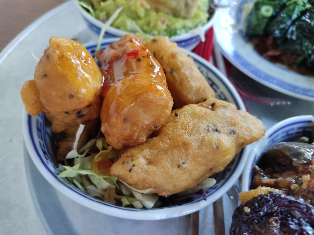 A bowl with four big beige chunks of food