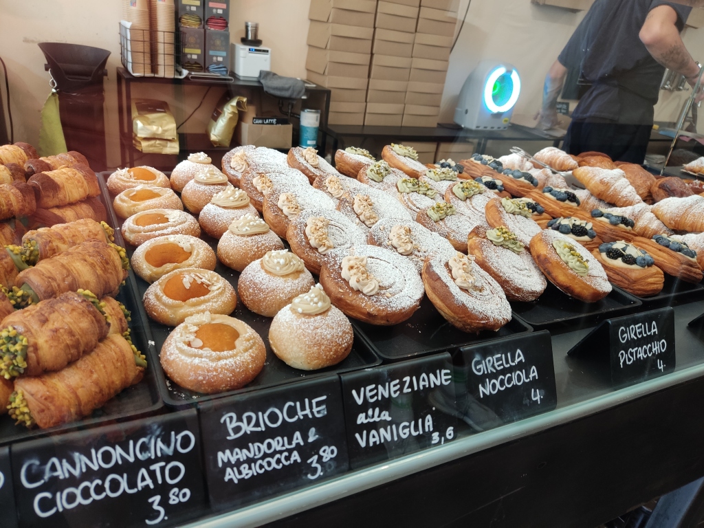 A bakery counter with about 8 different vegan pastry options to choose from