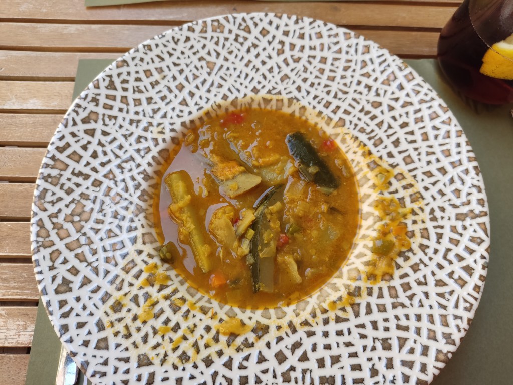 A bowl of vegetable soup, absolutely full of vegetable chunks