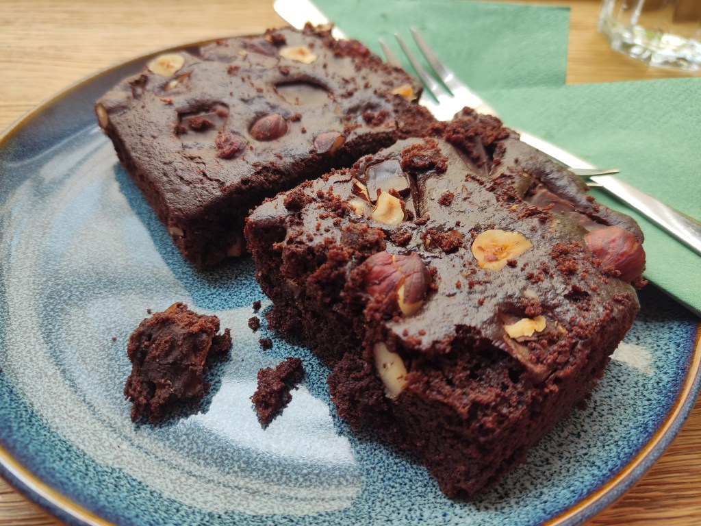 A plate with two hearty squares of chocolate cake with hazelnuts