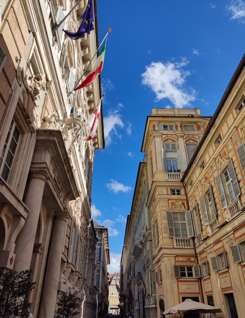 Some grand old buildings under a bright blue sky in Genoa