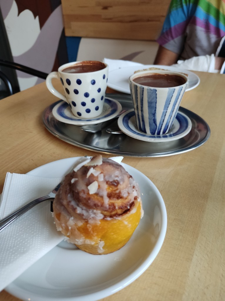 A pumpkin and cinnamon snail topped with icing and shredded coconut