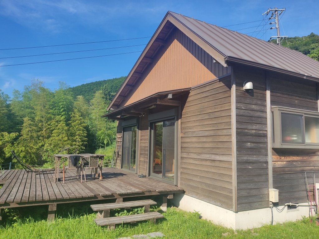 A wooden cottage with a large deck
