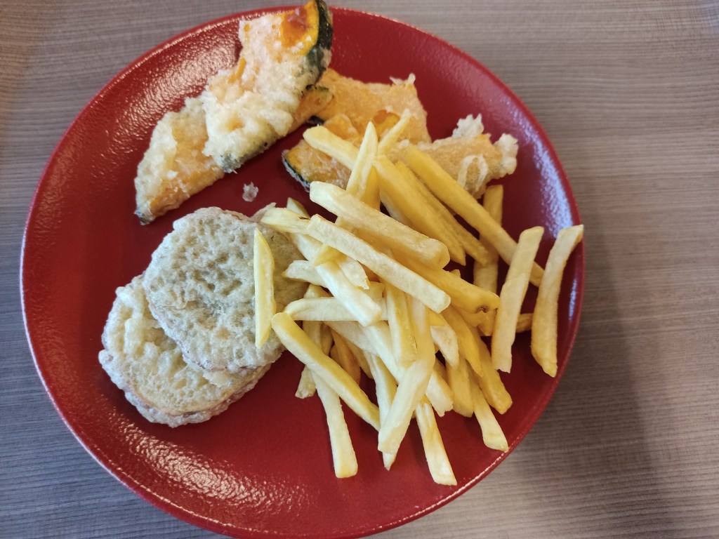 A plate of beige food, vegetable tempura and French fries
