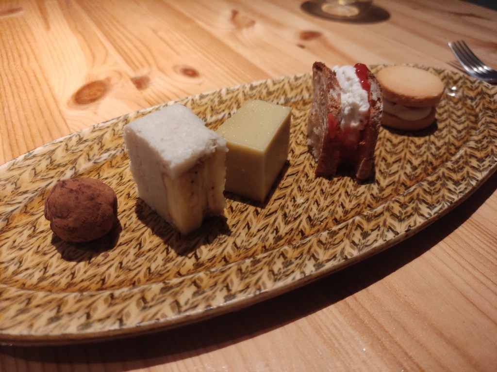 A plate with five different small desserts