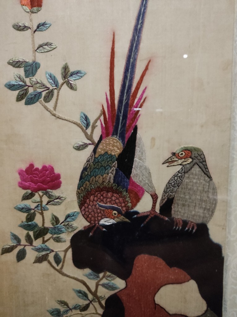 Two embroidered birds