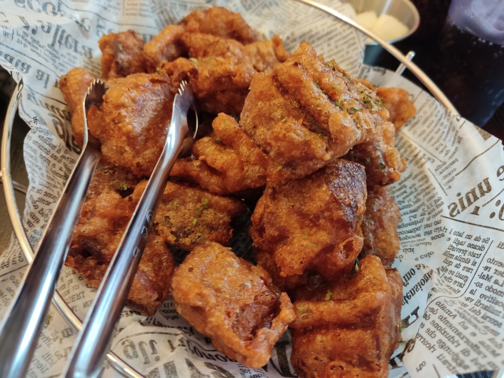 A close up of a basket of fried chicken