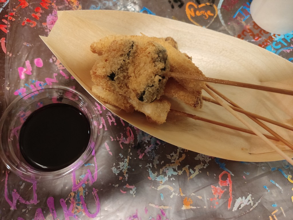 5 skewers of breadcrumbed vegetables with a dipping sauce