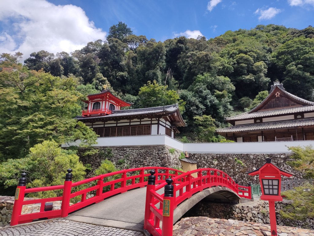 A red bridge leading to a temple