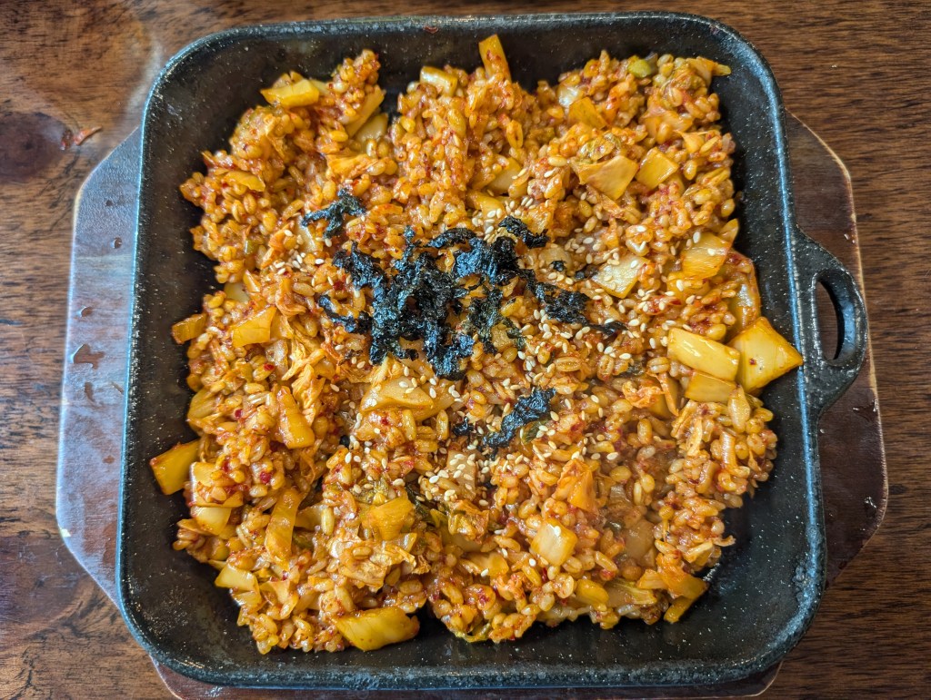 A big dish of fried rice topped with seaweed