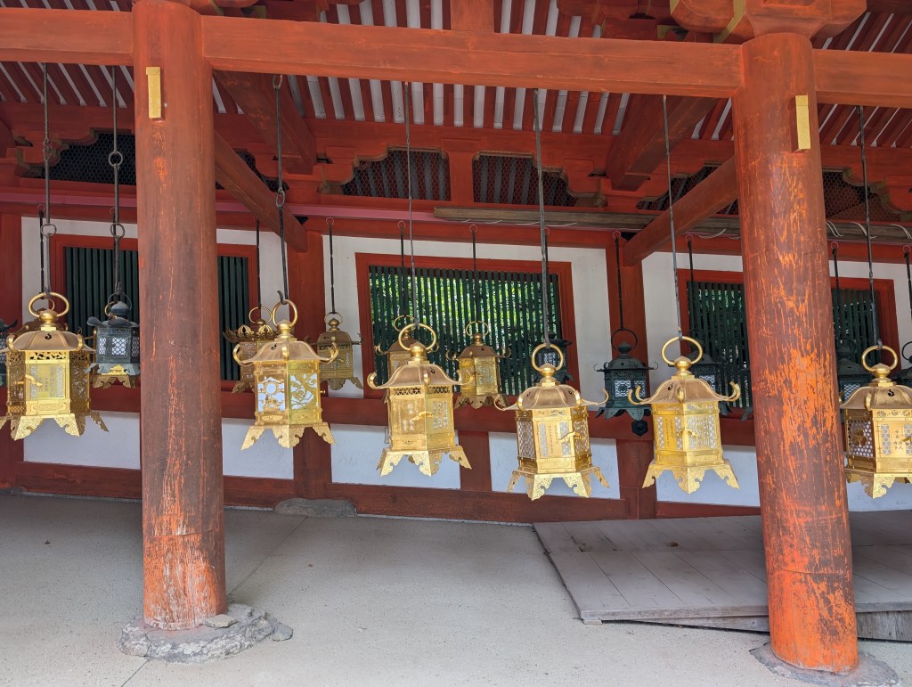 Gold lanterns hanging from railings in the shrine