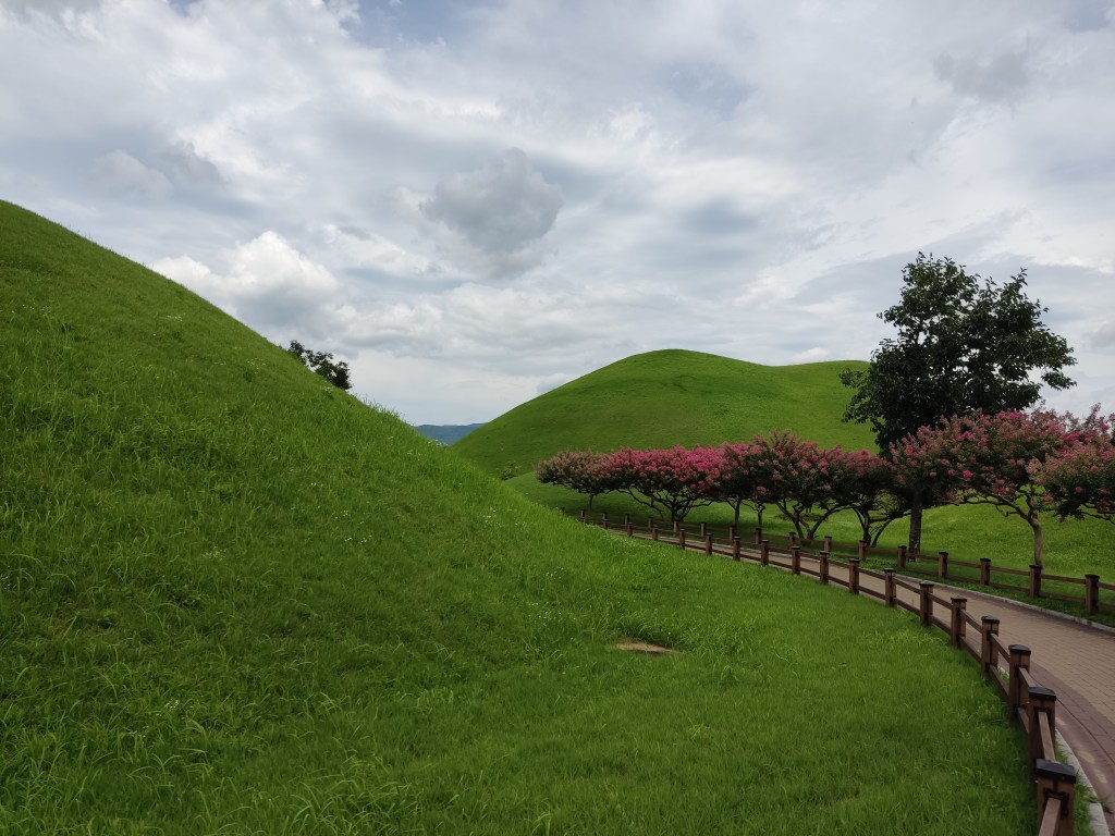 A path winding between ancient burial mounds