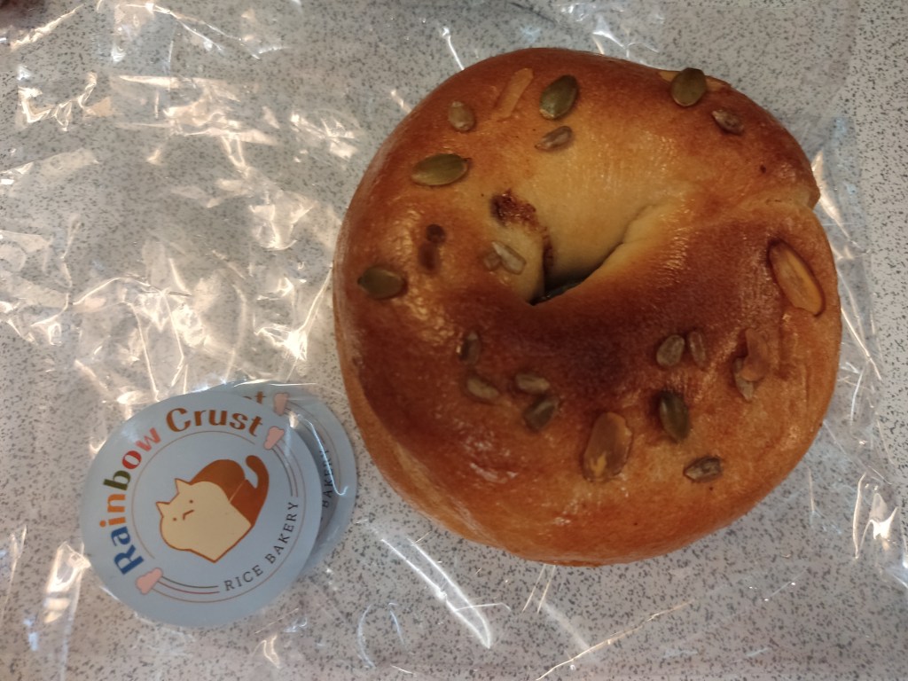 A bagel topped with a few seeds