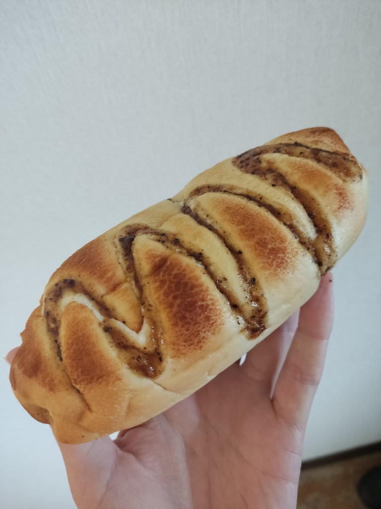 A long bun drizzled with a sticky peppery dressing