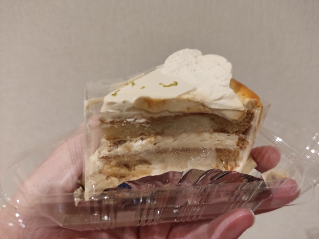 A slice of cake with layers of sponge and cream