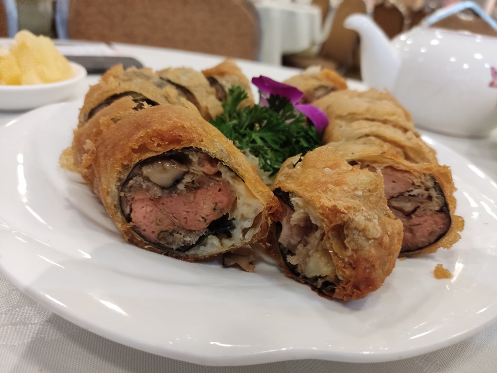 A plate of rolls with crispy skin and mock meat chunks inside