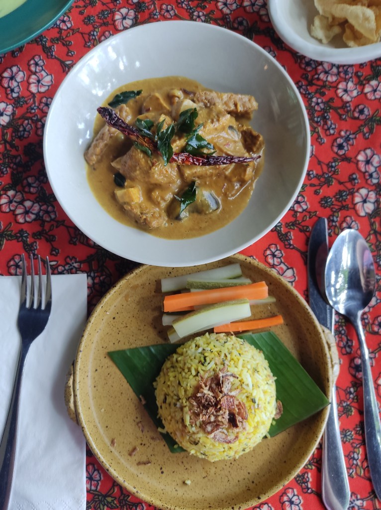 A bowl of rendang and a separate dish of rice