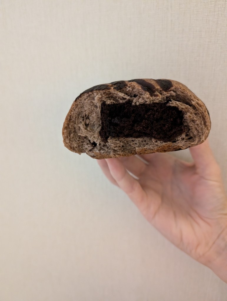 Inside a chocolate bun with a square of chocolate cake in the centre