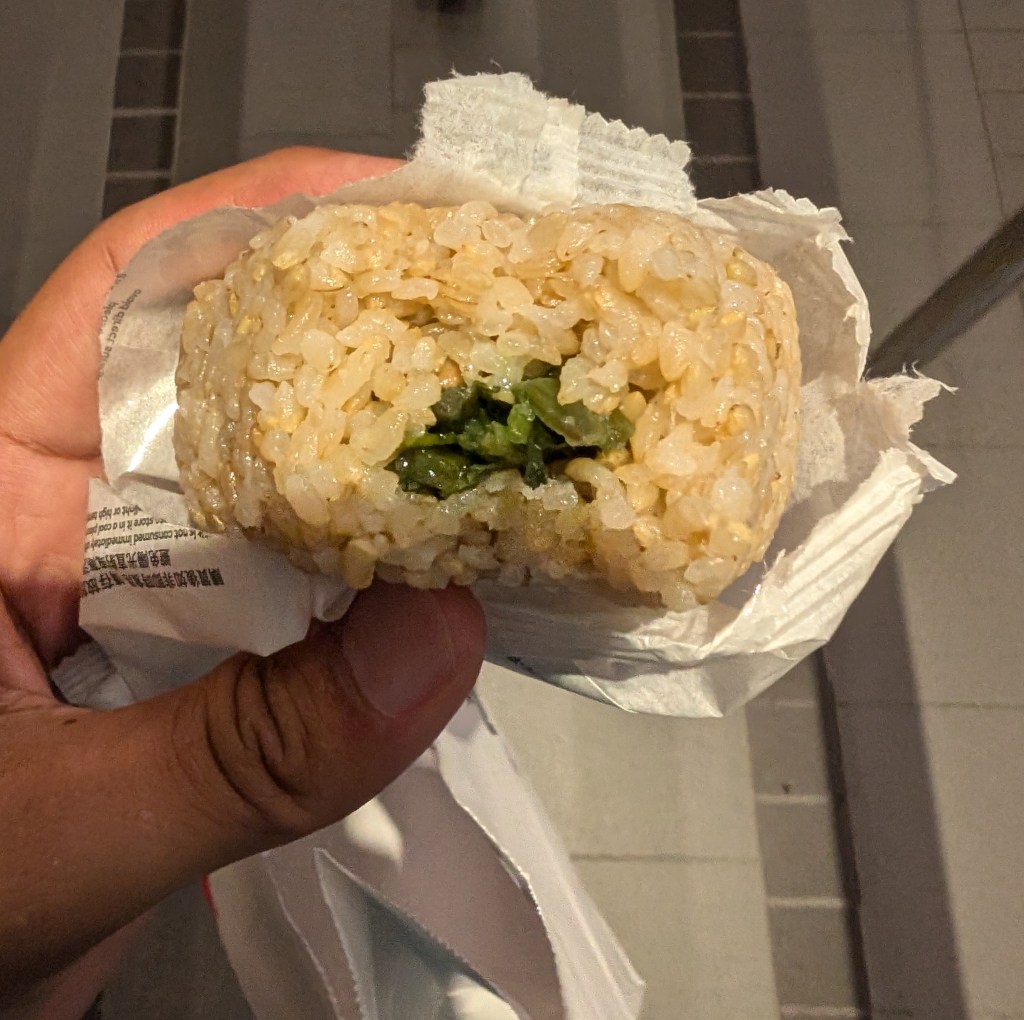 A rice ball with a leafy green filling