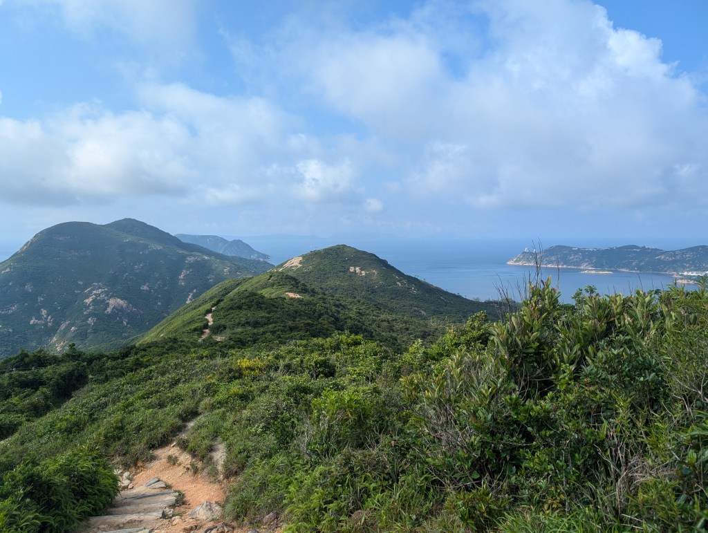 A view of sea and hills from the dragon's back hike