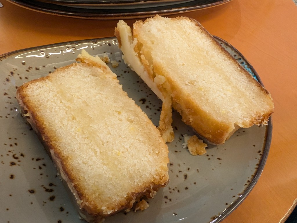 Two slices of lemon cake with a thin icing flaking off