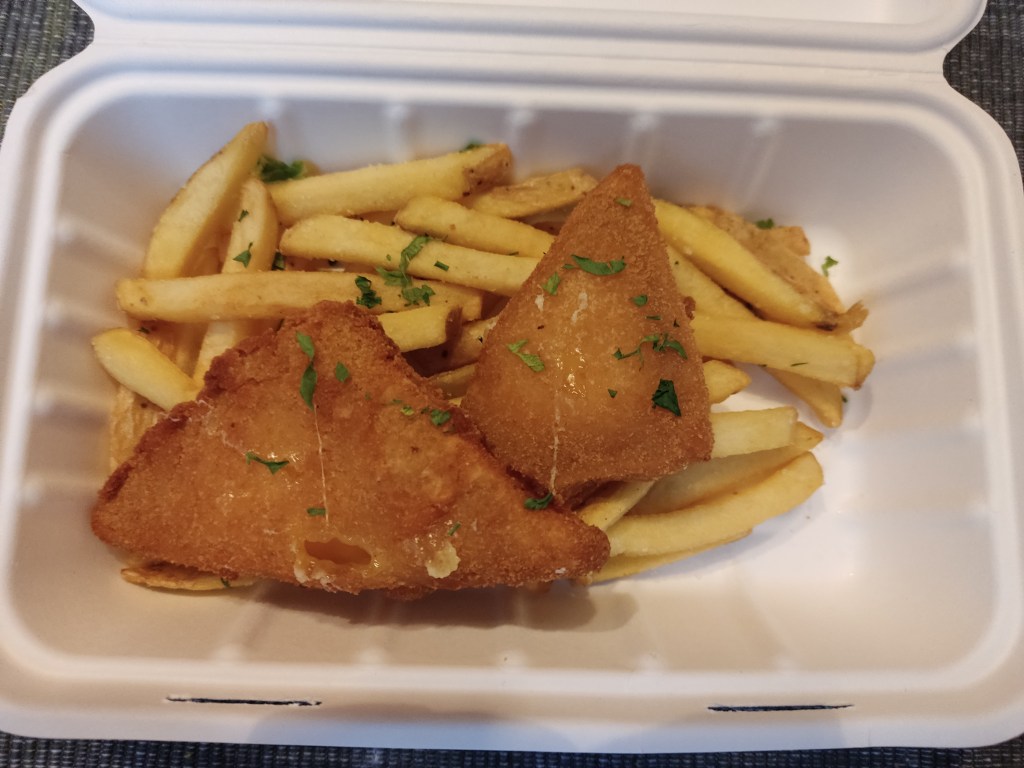 Two triangles of crispy deep fried cheese and a pile of chips in a takeaway box