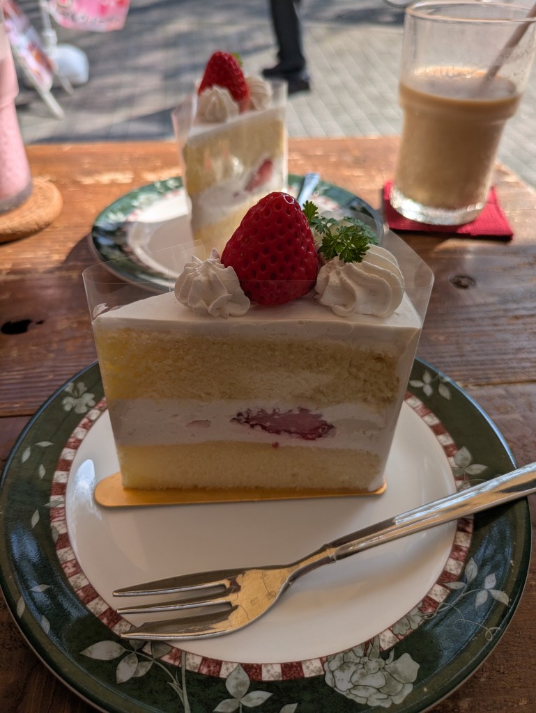 A layered sponge with cream and a few pieces of strawberry 