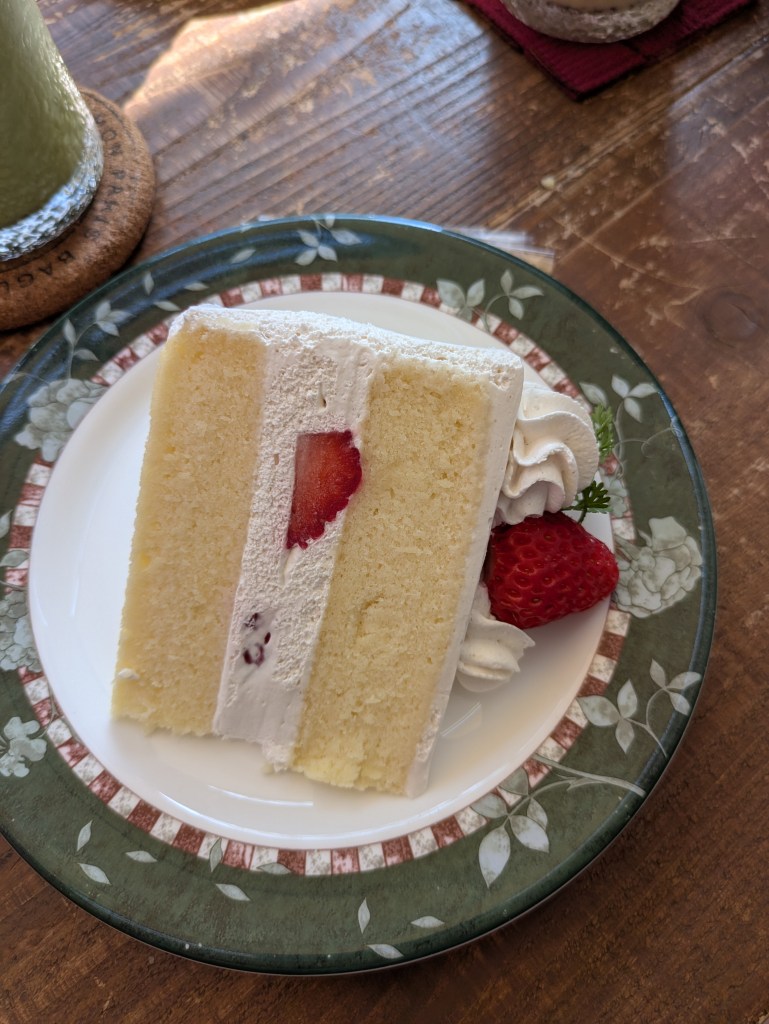 A layered sponge with cream and a few pieces of strawberry 