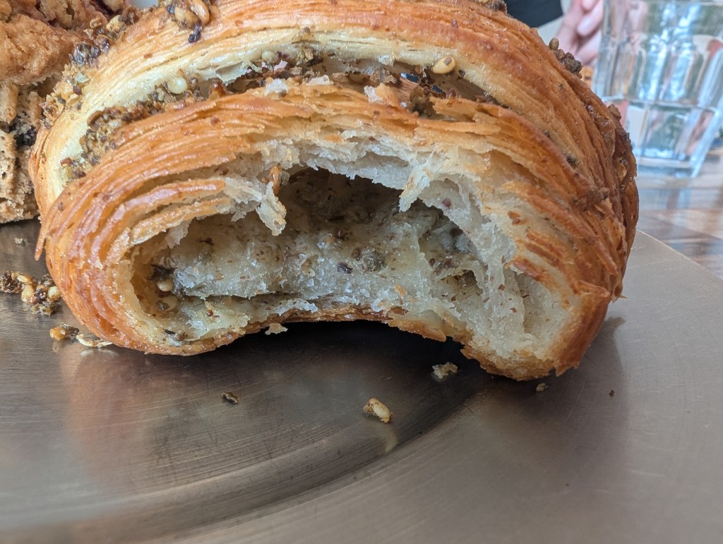 The inside of the croissant with crisp pastry layers and a seasoned filling