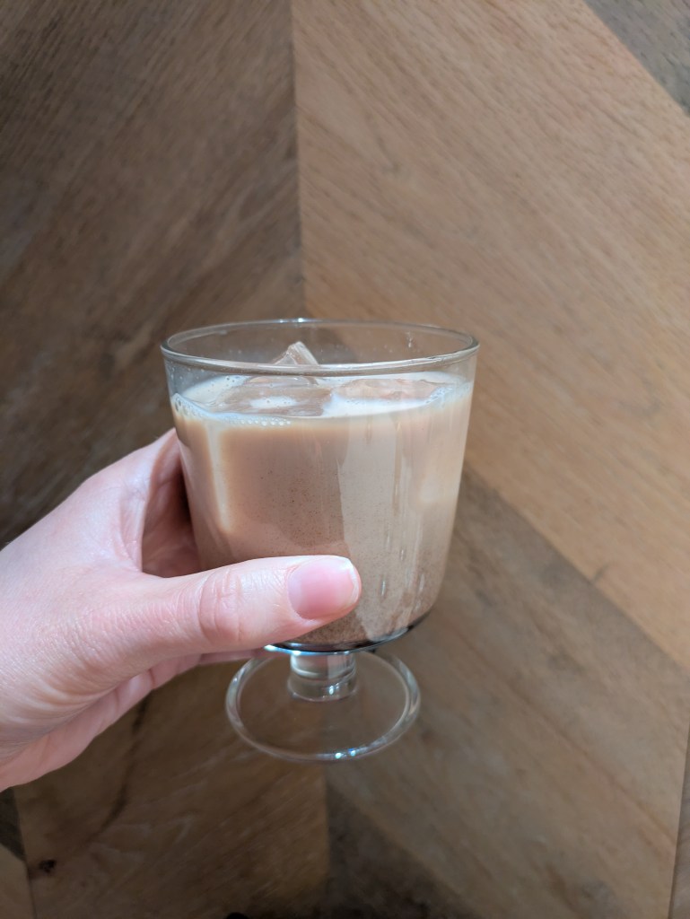 A small glass of iced milky tea