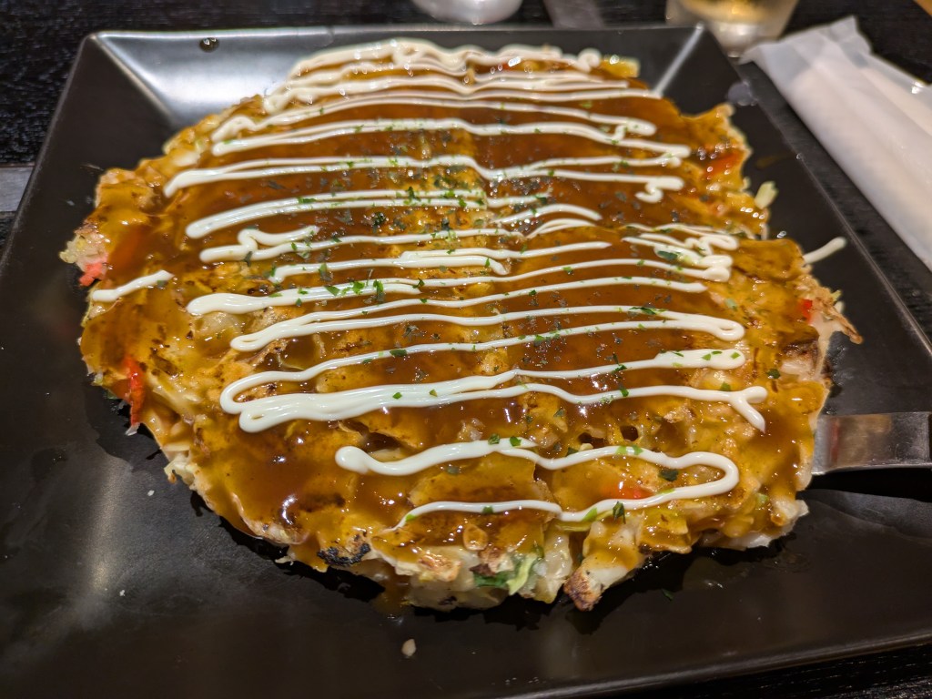 A big cabbage pancakes covered in sauce