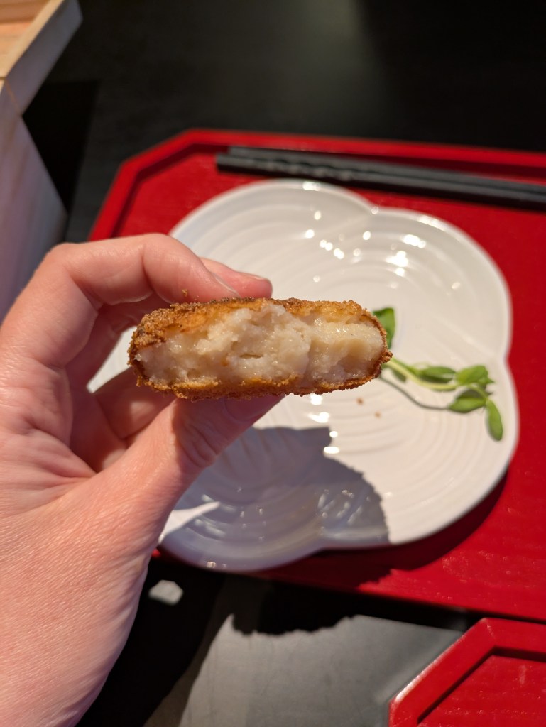 The inside of the croquette with a creamy white filling