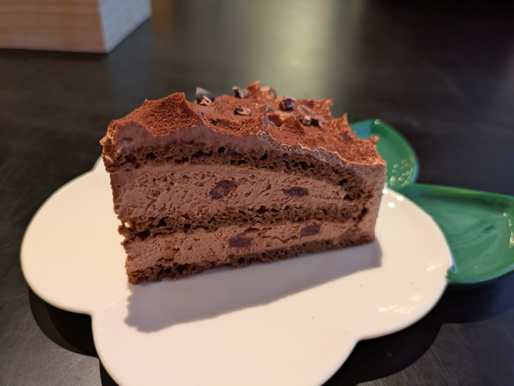 A chocolate cake featuring three very thin layers of sponge and lots of cream