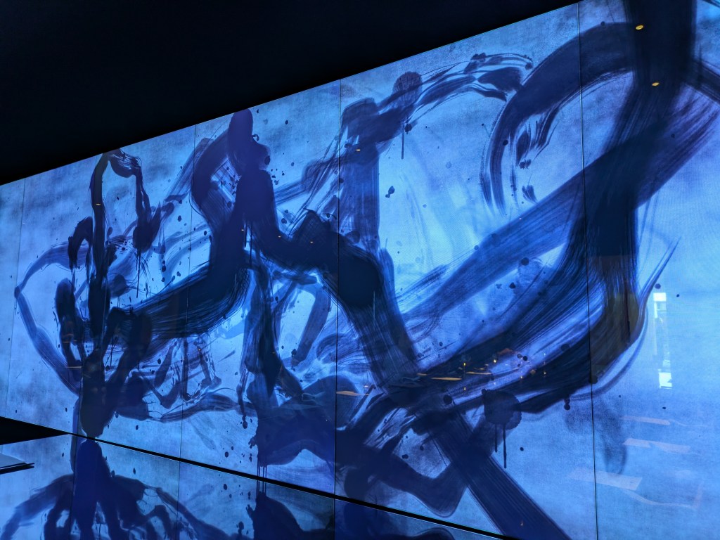 A digital art installation on the main wall of the restaurant