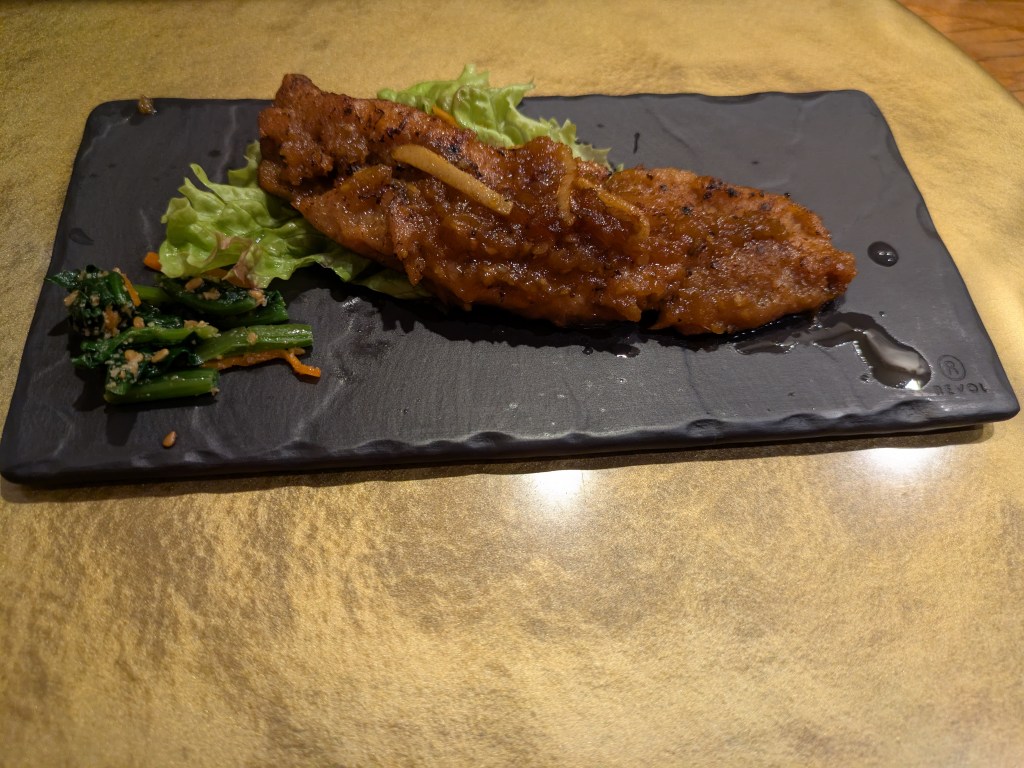 A big piece of mock meat with a few salad leaves