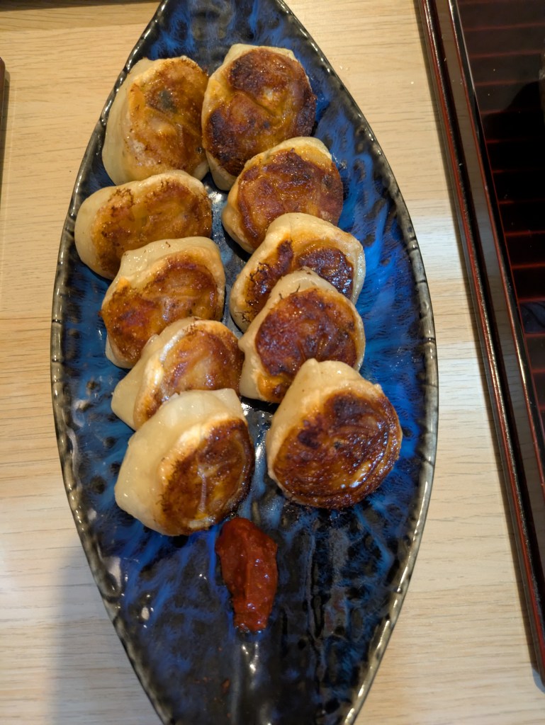 A plate of gyoza with well fried bottoms