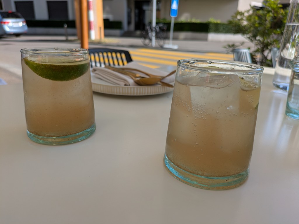 Two glasses filled with brownish fizzy drink